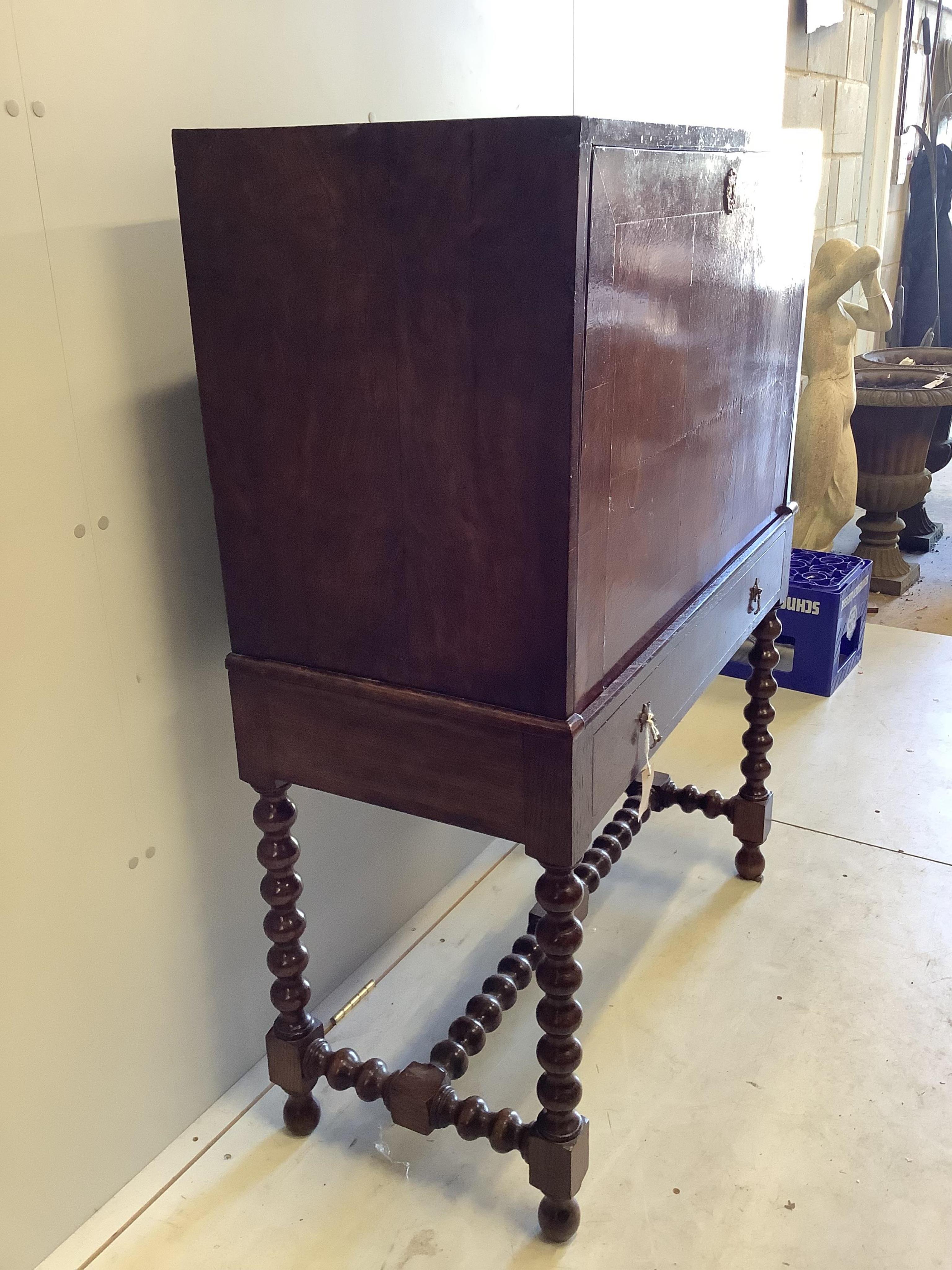 An 18th century walnut secretaire cabinet on later stand, width 91cm, depth 44cm, height 130cm. Condition - fair